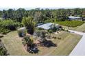 Exterior view of the property including shed, single Gathering home, and mature landscaping at 5769 E Price Blvd, North Port, FL 34288