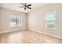 Bright and airy bedroom with tile flooring and natural light from two windows at 6160 Castleton Hollow Rd, Riverview, FL 33578