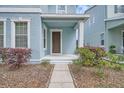 Inviting front porch with brown front door and landscaped surroundings at 6160 Castleton Hollow Rd, Riverview, FL 33578