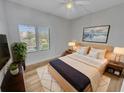 Cozy bedroom with a large window, comfortable bed, and stylish decor, creating a peaceful retreat at 557 Pinellas Bayway S # 111, St Petersburg, FL 33715