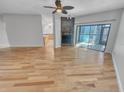 View of a hardwood floor living room with a fireplace and ceiling fan at 557 Pinellas Bayway S # 111, St Petersburg, FL 33715