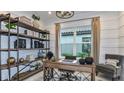 Well-lit office with a wooden desk, decorative shelving, and a comfortable chair at 6237 Plateau Ct, Bradenton, FL 34203