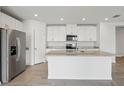Spacious kitchen with white cabinets, stainless steel appliances, and granite countertops at 31673 Wild Grape Sw Ln, Brooksville, FL 34602