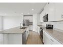 Bright kitchen features stainless steel appliances, granite countertops, and a large center island at 31673 Wild Grape Sw Ln, Brooksville, FL 34602