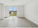 Bright, modern living room with sliding glass doors at 3561 Moscato Dr, Brooksville, FL 34602
