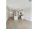 Bright living room with recessed lighting, tiled floors, and stainless steel appliances at 3561 Moscato Dr, Brooksville, FL 34602