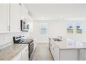 Bright kitchen with stainless steel appliances and a large island with a sink at 3568 Moscato Dr, Brooksville, FL 34602