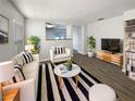 Bright living room featuring a white sofa, a black and white striped rug, and stylish decor at 5211 Mango Fruit St, Seffner, FL 33584