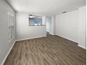 Bright living room with hardwood floors and neutral paint, offering a spacious feel at 5211 Mango Fruit St, Seffner, FL 33584