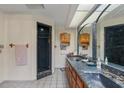 Bright bathroom with a marble countertop, double sinks, and a walk-in shower at 3634 Apfel Rd, Wesley Chapel, FL 33543