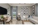 Stylish home office with a neutral color palette, plush sofa, herringbone floors, and modern accents at 6243 Plateau Ct, Bradenton, FL 34203