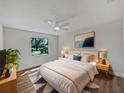 Sunlit bedroom features a plush bed, stylish nightstands, and a serene view from the large window at 3010 Pine Club Dr, Plant City, FL 33566