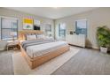 Bright bedroom with a large bed, modern decor, and natural light from two windows at 5954 Caldera Ridge Dr, Lithia, FL 33547