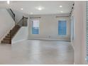 Spacious living room featuring tile floors, staircase, and large windows at 5954 Caldera Ridge Dr, Lithia, FL 33547