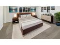 Modern bedroom with a plush rug, and a stylish dresser below a window with black blinds at 8340 75Th Pl, Seminole, FL 33777