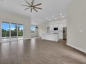Bright, open-concept living space features wood-look tile and sliding glass doors at 15741 Autry Cir, Port Charlotte, FL 33981