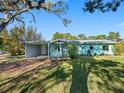 The lovely home showcases a well-kept lawn, carport, and cozy front porch at 5275 Miller Bayou Dr, Port Richey, FL 34668