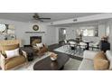 Beautiful living room and dining area with fireplace and stylish furnishings at 13794 Marseilles Ct, Clearwater, FL 33762