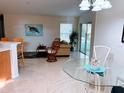 Bright living area with tile floors, sliding glass door, and neutral walls at 4845 Post Pointe Dr, Sarasota, FL 34233