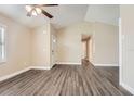 Open living room with neutral walls, updated ceiling fan and luxury vinyl plank flooring at 7001 Heath Dr, Port Richey, FL 34668
