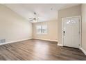 Bright living room features neutral walls, updated ceiling fan and luxury vinyl plank flooring at 7001 Heath Dr, Port Richey, FL 34668