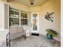 Welcoming front porch featuring a bench and decorative details at 4949 Sandy Glen Way, Wimauma, FL 33598