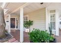 Charming porch with wood flooring, supported by white columns with a beautiful front door at 3304 W Granada St # A, Tampa, FL 33629