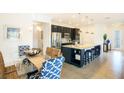 Open-concept kitchen with stainless steel appliances and granite island at 150 Castile Ct, Punta Gorda, FL 33983