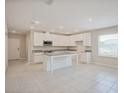 Bright kitchen features stainless appliances, granite counters, and a center island at 25880 Prada Dr, Punta Gorda, FL 33955