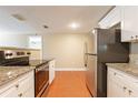 Bright kitchen featuring stainless steel appliances, granite countertops, and white cabinets at 3201 Cord St, Tampa, FL 33605