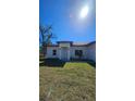 Charming single-story home with a well-manicured lawn under a clear blue sky at 17065 Malta Ave Ave, Port Charlotte, FL 33954