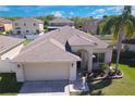 An aerial view of the home's exterior, showcasing its architecture and well-manicured lawn at 27452 Amelia Isle Ct, Wesley Chapel, FL 33544