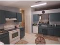 Functional kitchen featuring tiled floors and matching cabinetry with ample counter space at 2632 Wrencrest Cir, Valrico, FL 33596