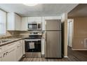 Bright kitchen with stainless steel appliances, granite countertops, and new cabinets at 9811 Rainbow Ln, Port Richey, FL 34668