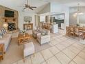 Bright living room with stone fireplace, open layout to kitchen and dining, and neutral decor at 13103 Mink Run, Hudson, FL 34669