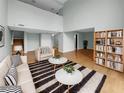 Bright living room boasts hardwood floors, tall ceilings, and modern decor and a bookshelf at 13516 Palmwood Ln, Tampa, FL 33618
