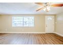 Inviting living room with modern laminate flooring and a large window, perfect for relaxation at 4218 E Paris St, Tampa, FL 33610