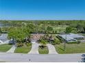 Panoramic aerial view of a well-manicured home with lush landscaping and a nearby golf course at 650 Poinsettia Rd, Belleair, FL 33756