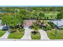 An aerial view of a lovely property showcases a spacious backyard with pool and golf course views at 650 Poinsettia Rd, Belleair, FL 33756