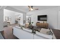 Bright living room with hardwood floors seamlessly connects to the dining area and open kitchen at 1206 E Hamilton Ave, Tampa, FL 33604