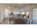 Open-concept living and kitchen area with lots of natural light, and a dining table at 36137 Canelli Way, Dade City, FL 33523