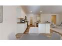 Spacious kitchen featuring white cabinets, stainless steel appliances, and an eat-in breakfast bar at 36183 Canelli Way, Dade City, FL 33523