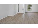 Bright living area with modern wood-look floors and an inviting entryway at 6741 64Th E Ter, Bradenton, FL 34203