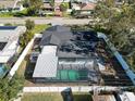 Aerial view of the home's backyard featuring a screened-in pool and fully fenced yard at 4907 21St W Ave, Bradenton, FL 34209