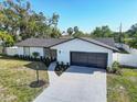 Single-story home with a well-kept lawn, tidy landscaping, and a gray two-car garage at 4907 21St W Ave, Bradenton, FL 34209