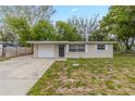 Inviting single-story home featuring a well-maintained front lawn, front door, and attached one-car garage at 4129 Highland Loop, New Port Richey, FL 34652