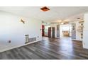 Open-concept living room featuring sleek gray wood flooring, perfect for entertaining and relaxation at 10105 Vineyard Ln, Port Richey, FL 34668