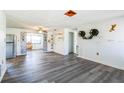 Bright and airy living room featuring sleek gray flooring, custom cat accessories, and an open floor plan at 10105 Vineyard Ln, Port Richey, FL 34668