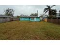 Exterior view of this turquoise single-story home with a spacious backyard, great for outdoor living at 2155 Webber St, Sarasota, FL 34239