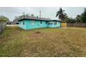 Turquoise home featuring a spacious lawn and a corner-lot with mature trees at 2155 Webber St, Sarasota, FL 34239
